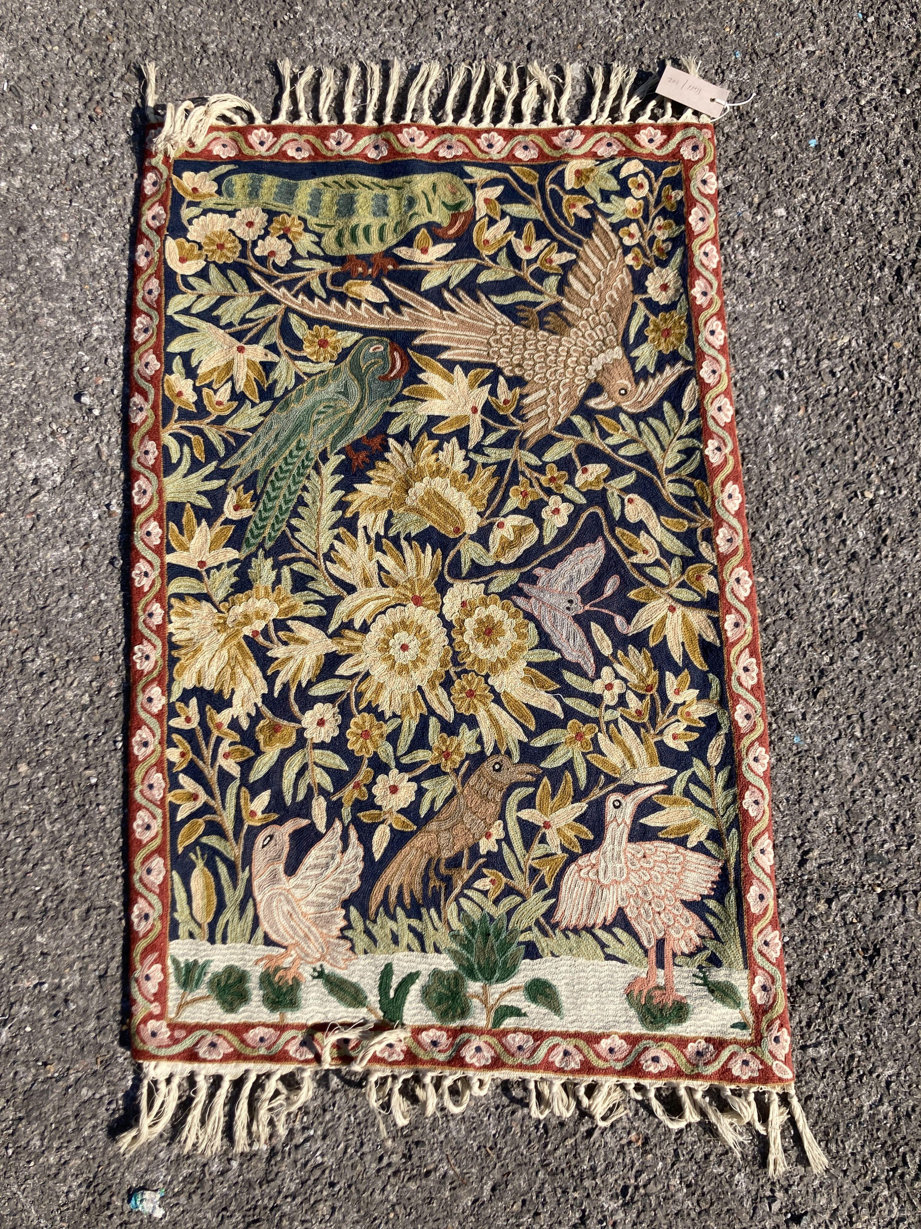 An Indian embroidered wall hanging panel, decorated with birds and foliage, 90 x 60 cms.